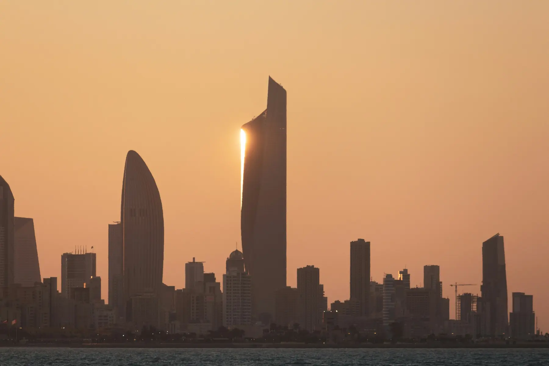 Kuwait City skyline glowing at sunset